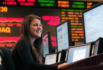 A student in the financial trading floor room