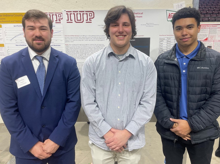Financial Institutions & Markets student poster presenters (l to r):  Gage Henry, Caleb Johnson, and Myca Torreance