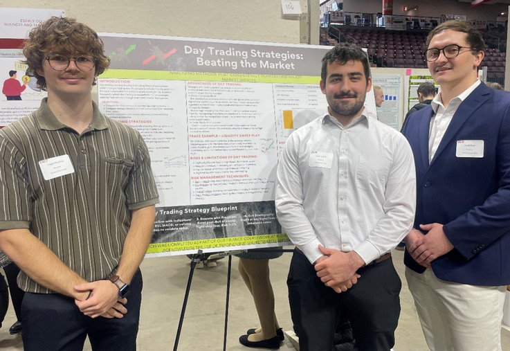 Financial Institutions & Markets student poster presenters (l to r):  Logan Mumma, Isaac Griffith, and Jacob Rose