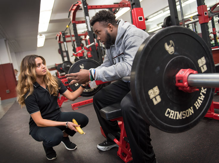 A dietetic intern nutrition coaching an IUP football player so that he can optimize his performance on the field.