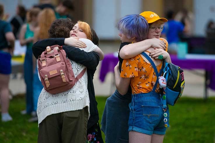 Several students hugging each other in the Oak Grove during a previous Take Back the Night event