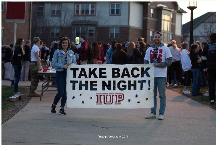 Students holding a sign at Take Back the Night 2019
