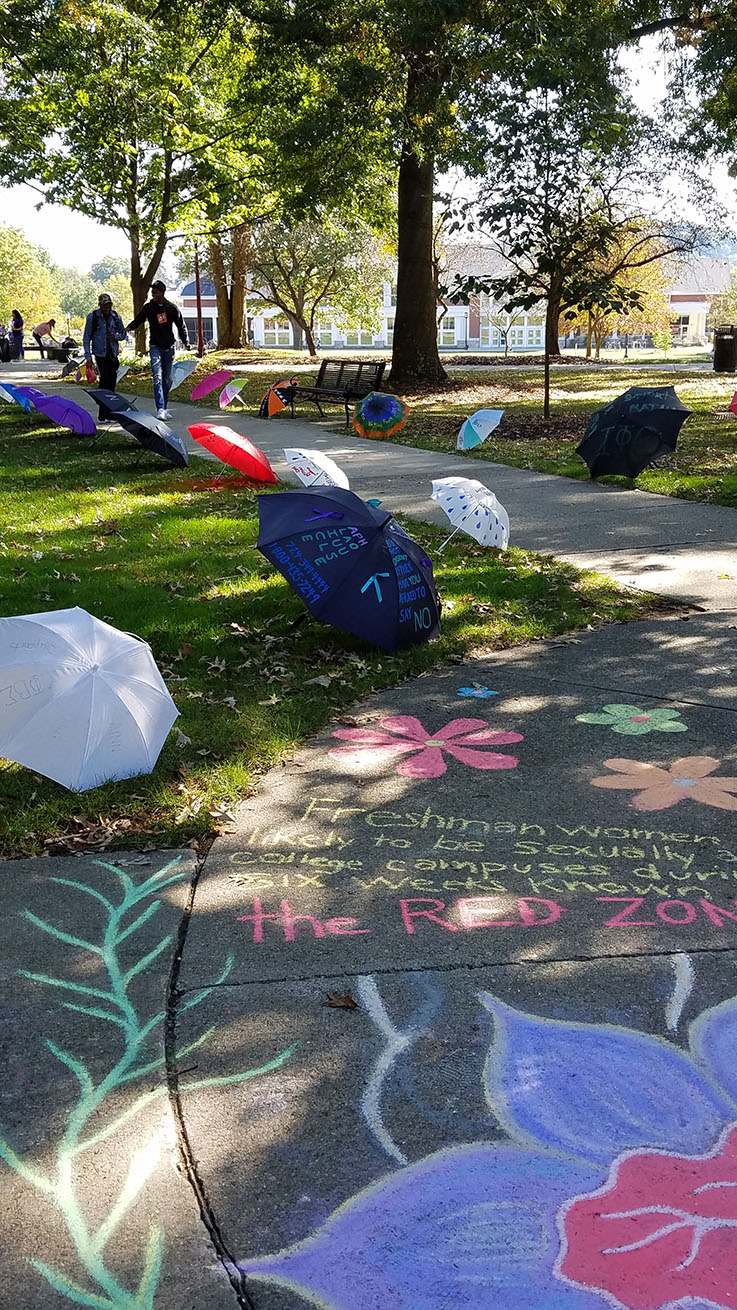 photo from a past RAINN Day showing the umbrella display in the Oak Grove