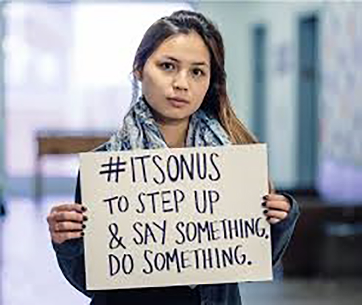 girl holding a sign that says #it's on us to step up and say something, do something