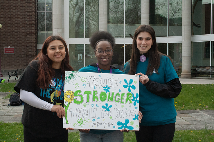 students holding a sign of support