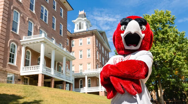 Norm posing in front of Sutton Hall