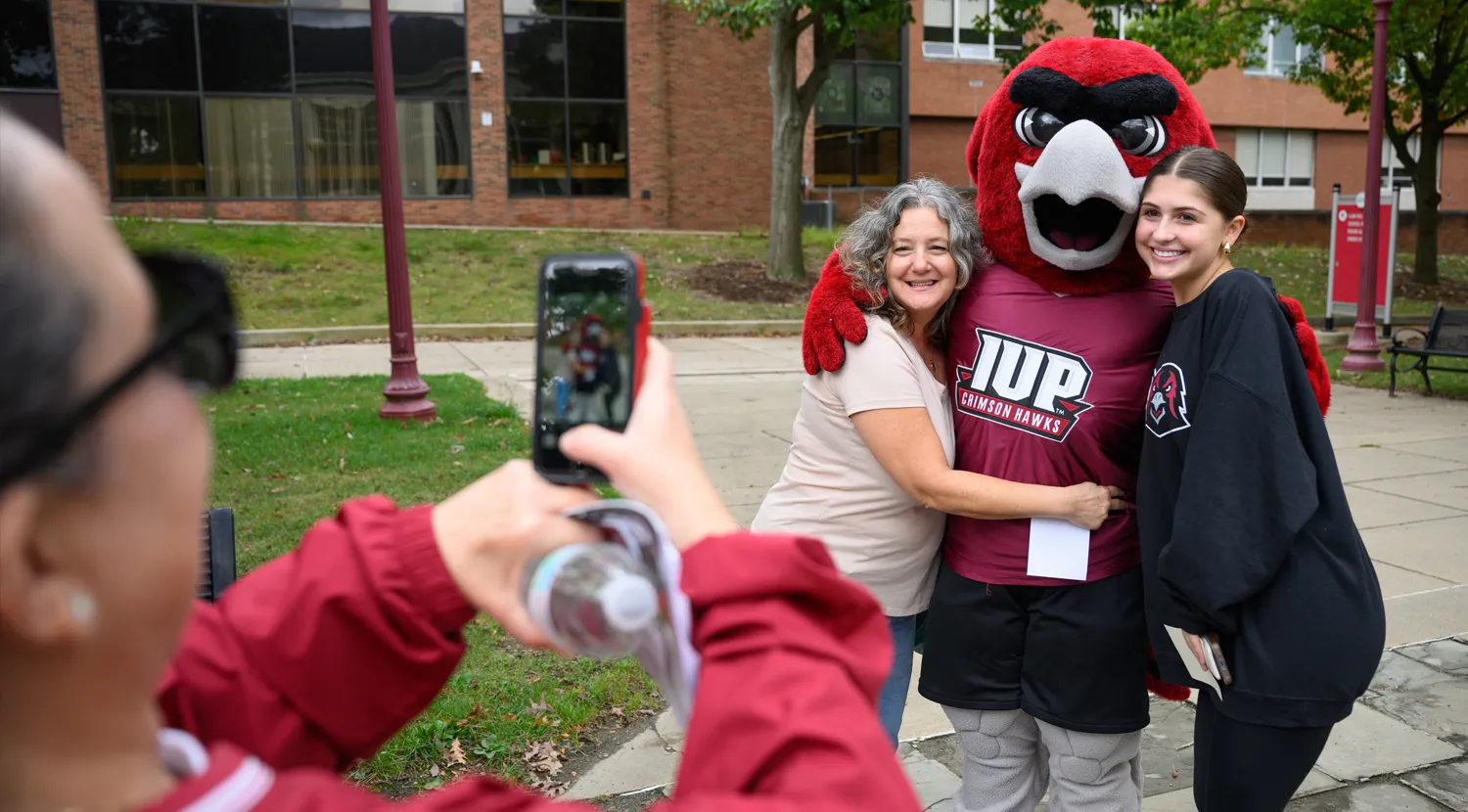 Norm posing for a photo with a group of people
