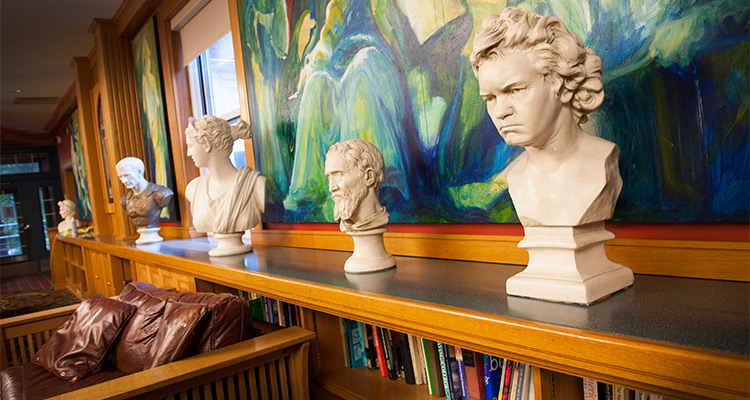 Four statues in the Honors College building