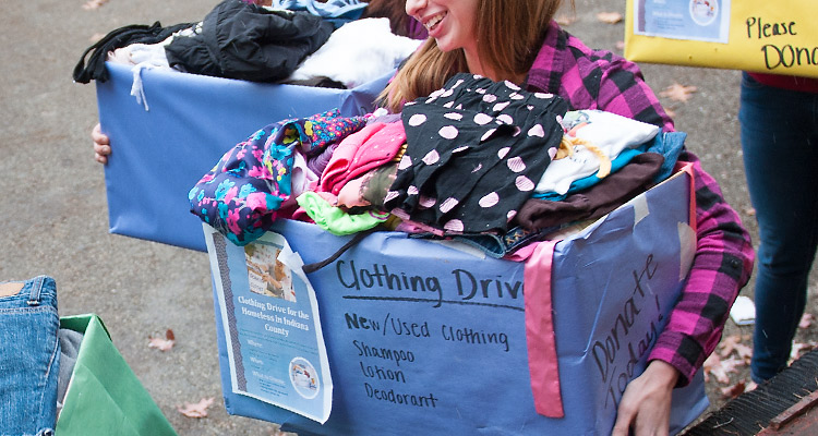 Female holding a clothing drive box 