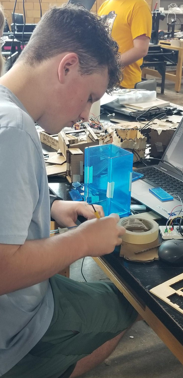 A student builds his project in the STEAMSHOP.