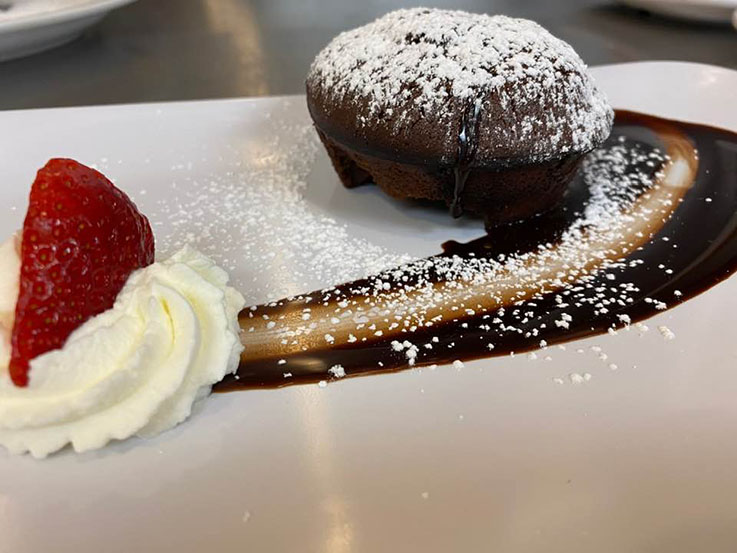 Chocolate lava cake with strawberry garnish