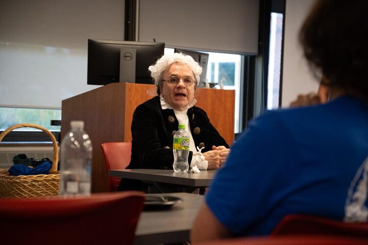 History professor Joe Mannard, portraying James Madison, speaks with students during IUP’s Constitution Day program.