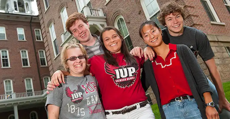 A group of students posing for a photo outside Sutton Hall