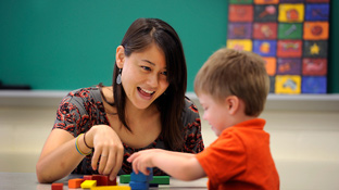 An education student interacts with a child