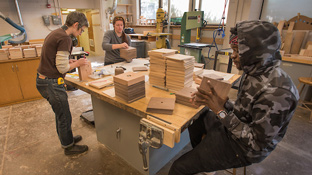 Students work with a professor in the Wood Center