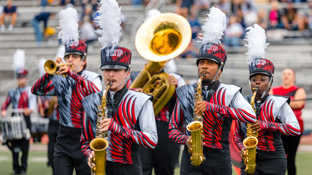 students in the iup marching band perform on the field