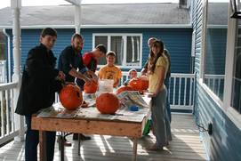 International students carving pumpkins