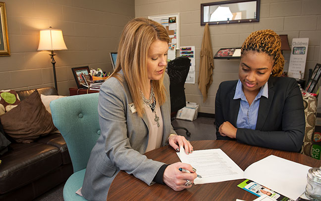 The director of the Career and Professional Development Center helps a student
