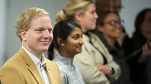 A lineup of students smiling facing to the right