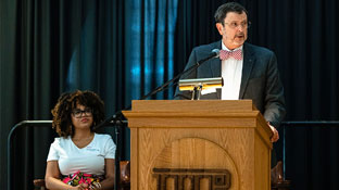 Dr. Driscoll at a podium presenting an award