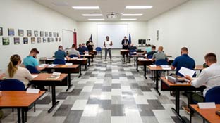 A symmetrical style photo of a professor addressing a class of students