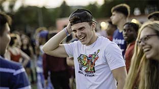 Smiling students at outdoor Welcome Week festivities.