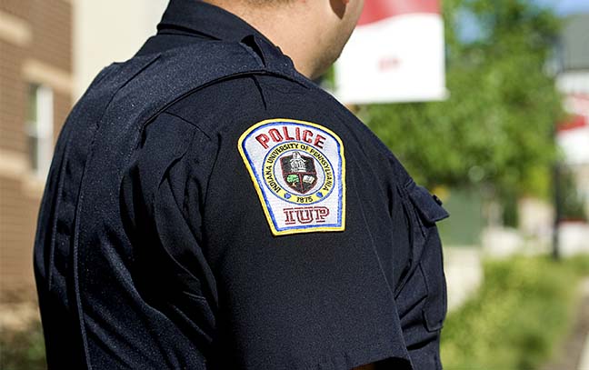 a close up of a university police officers shoulder showing his uniform and  IUP Police shoulder patch