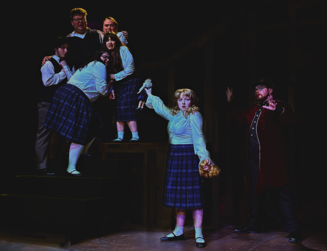 Cast members in a dramatic moment from "Ride the Cyclone"