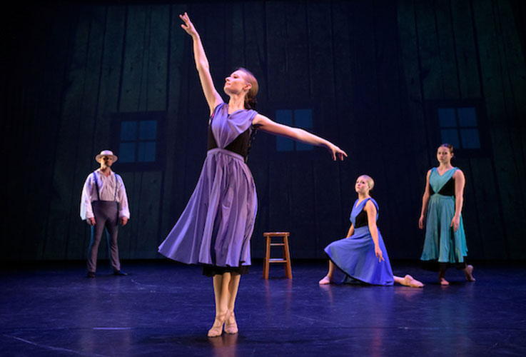 Dancers dressed in Amish-style dresses perform on stage