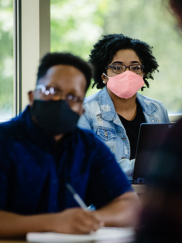 Masked students in a classroom Masked students in a classroom