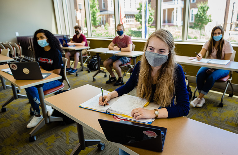 Masked students in a classroom Masked students in a classroom