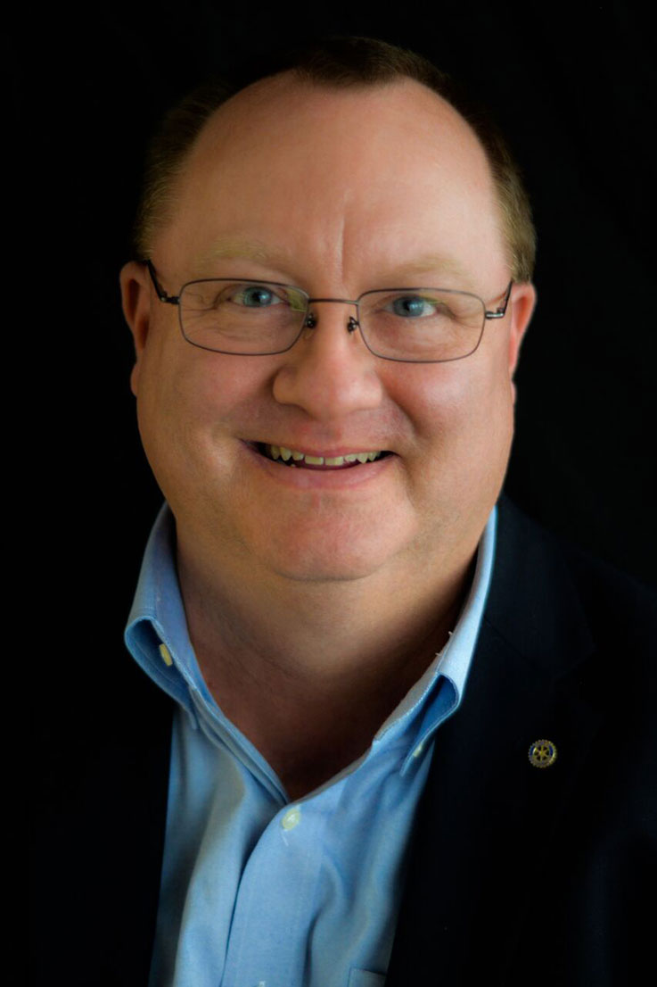 Vic Conrad head-and-shoulders portrait on a black background