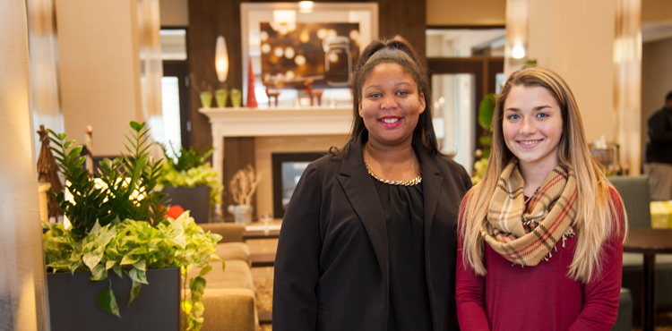 Two students in the lobby of a hotel