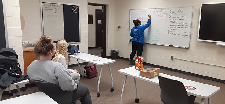 Micayla Schambura, Elizabeth Lee, and Mikayla Dokos in the classroom