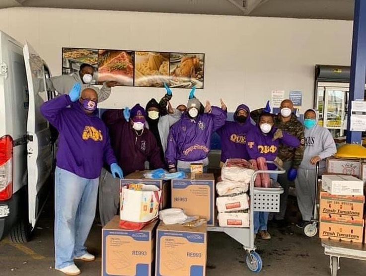 A group photo of the members of Omega Psi Phi working together.
