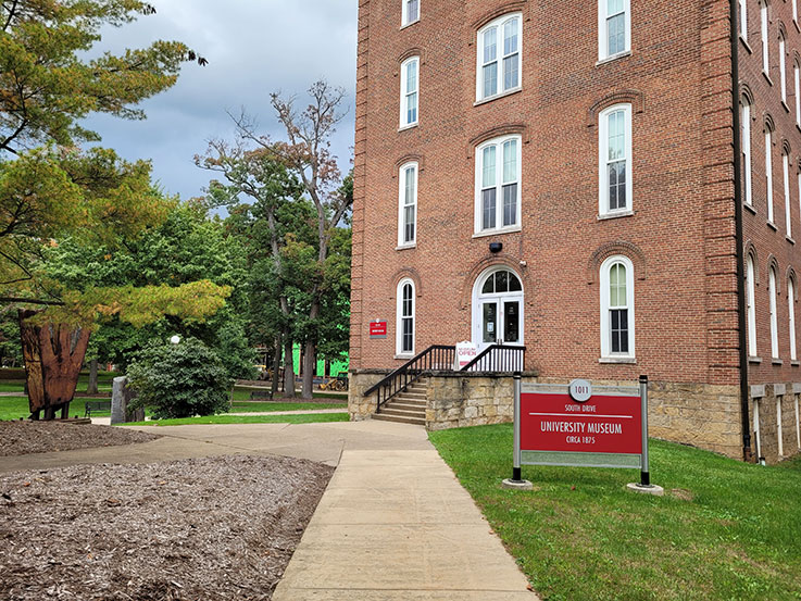 Photograph of the exterior of Sutton Hall at the University Museum entrance.