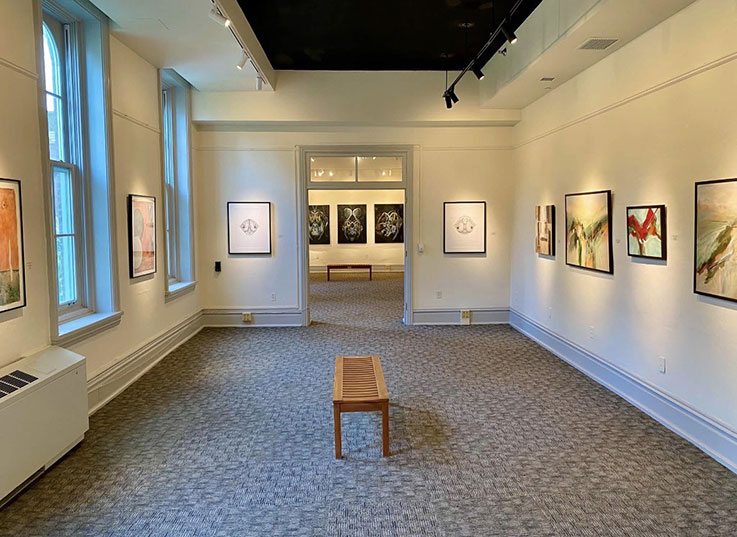 photographic image of several galleries within the University Museum with several artistic works displayed on the walls