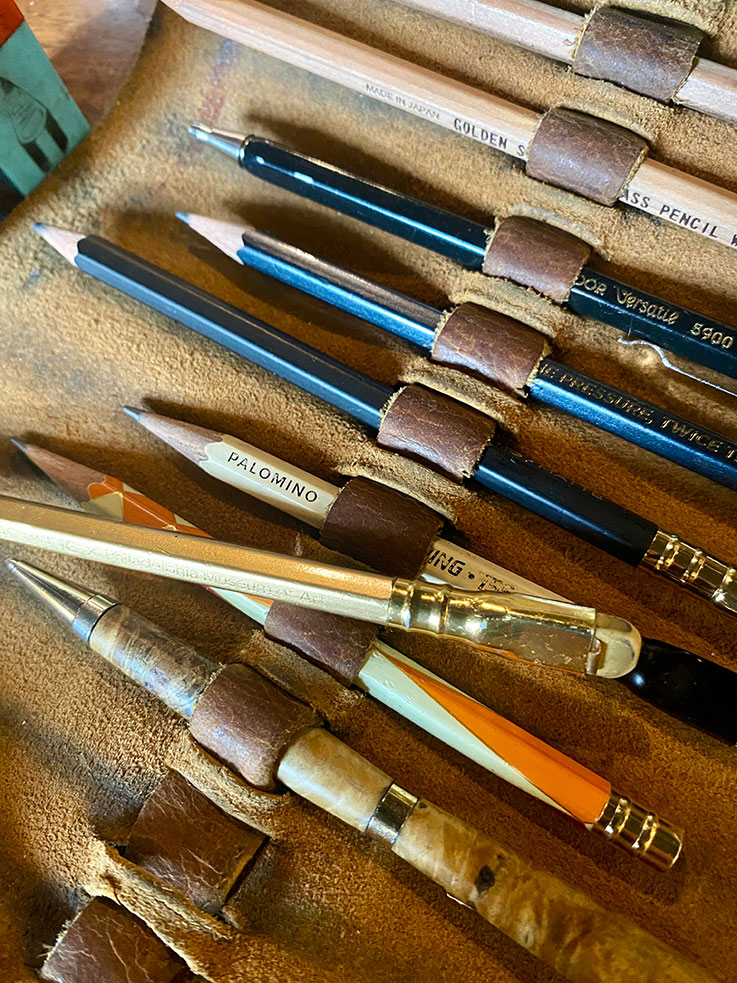 old pencils lined up in a case