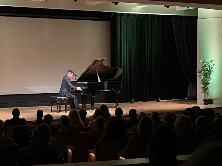 Henry Wong Doe playing piano on stage