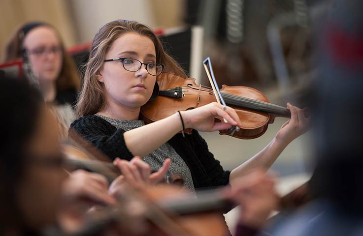 female student playing violin