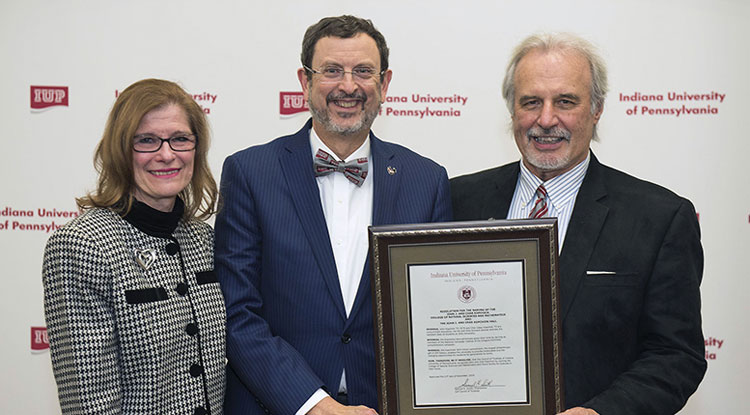 John and Char Kopchick and President Driscoll with the resolution to name the new Natural Sciences and Math building after the Kopchicks 