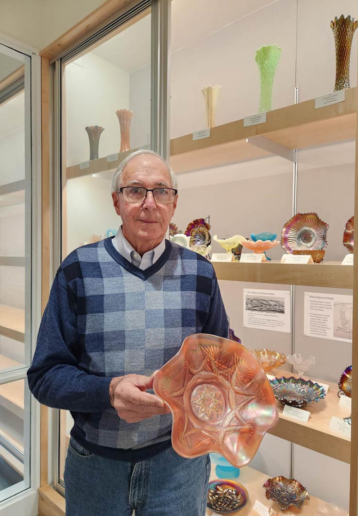 Arnold Wolfe with a piece of Indiana Glass from his collection
