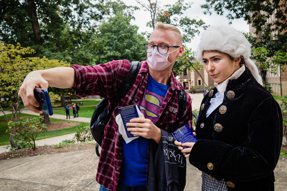a student taking a selfie with someone dressed as a founding father