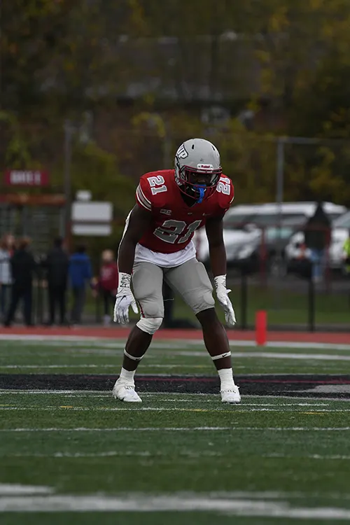 Darius Bruce in football pads standing on the field