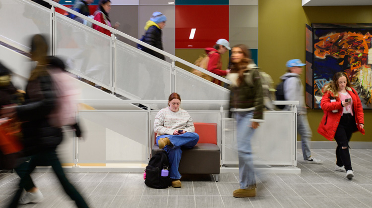 students walking through jane leonard hall near the stairs