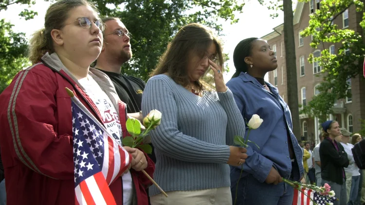Students holding flags and mourning in the Oak Grove during the first 9/11 memorial ceremony