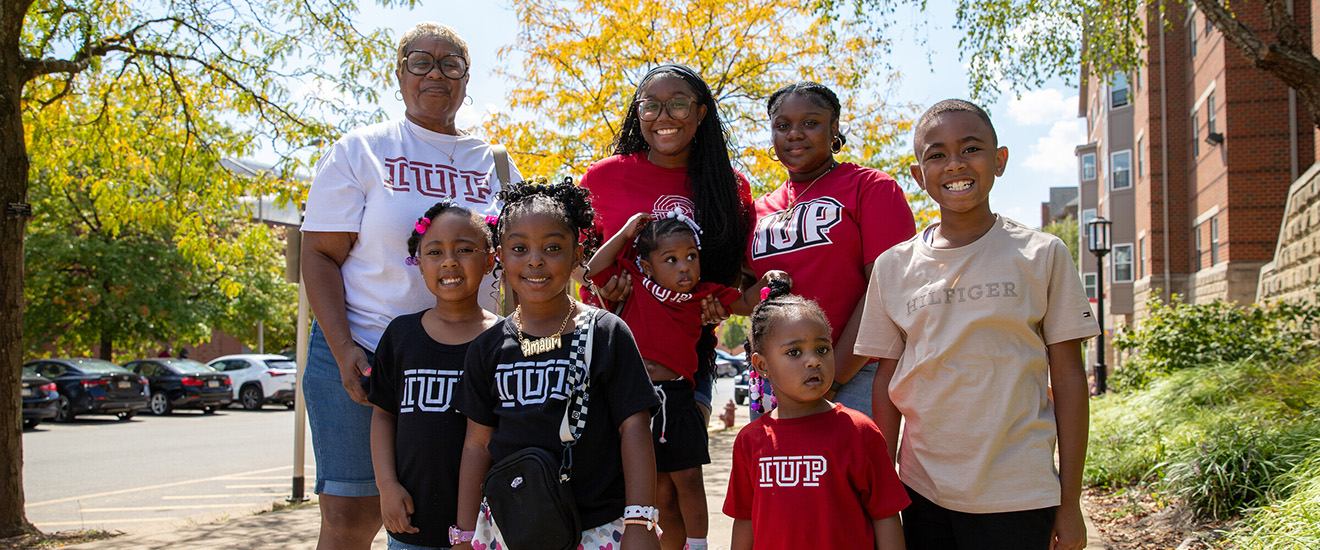 A large family with IUP shirts on pose together on Family Weekend. 