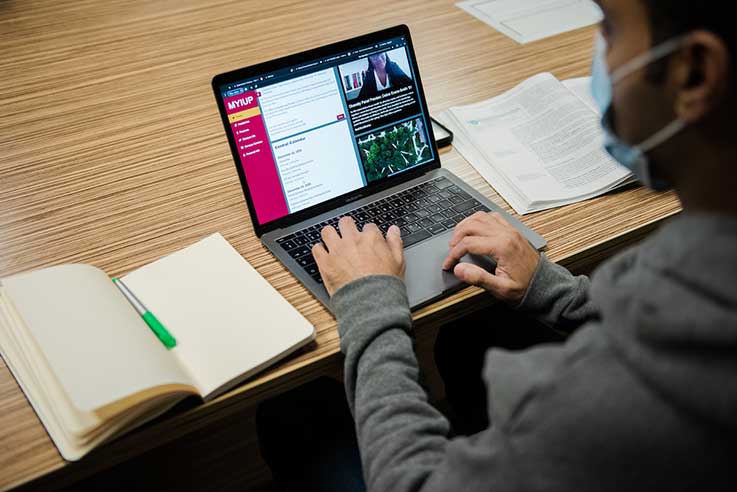 Person at a desk looking at the MyIUP website on their computer.