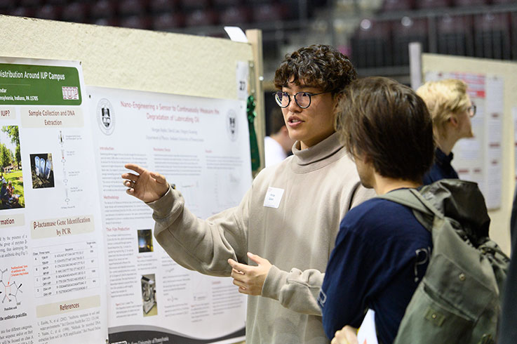 Student presenting a research post during IUP Research Appreciation Week