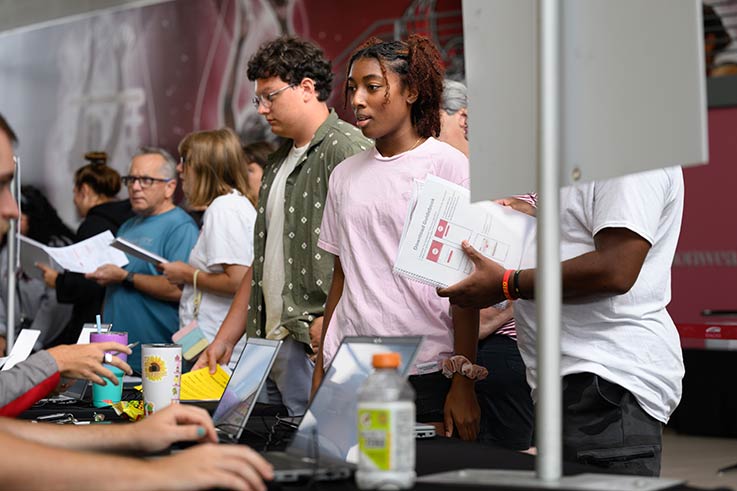 Students at an information table during Move-in 2024